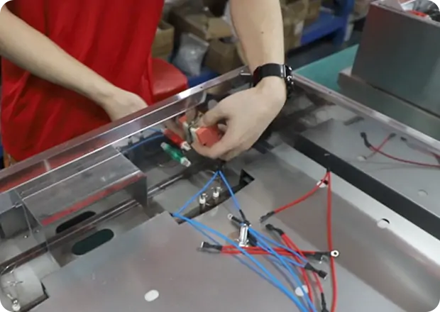 Assembly technicians building commercial electric fryer units for restaurant applications
